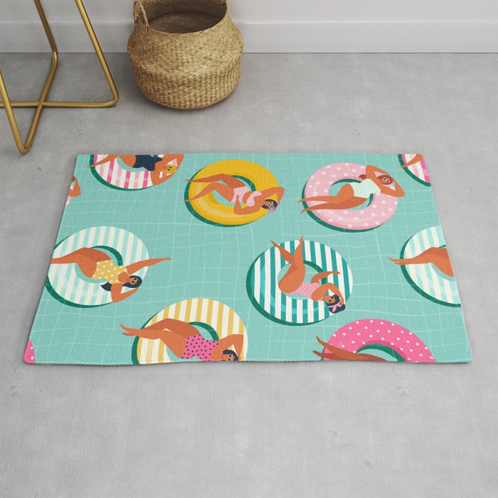 Summer gils on inflatable in swimming pool floats. Rug
