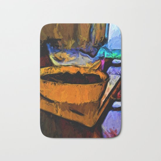 Gold Dish with Chocolate in the Shadow of a Glass Bowl Bath Mat