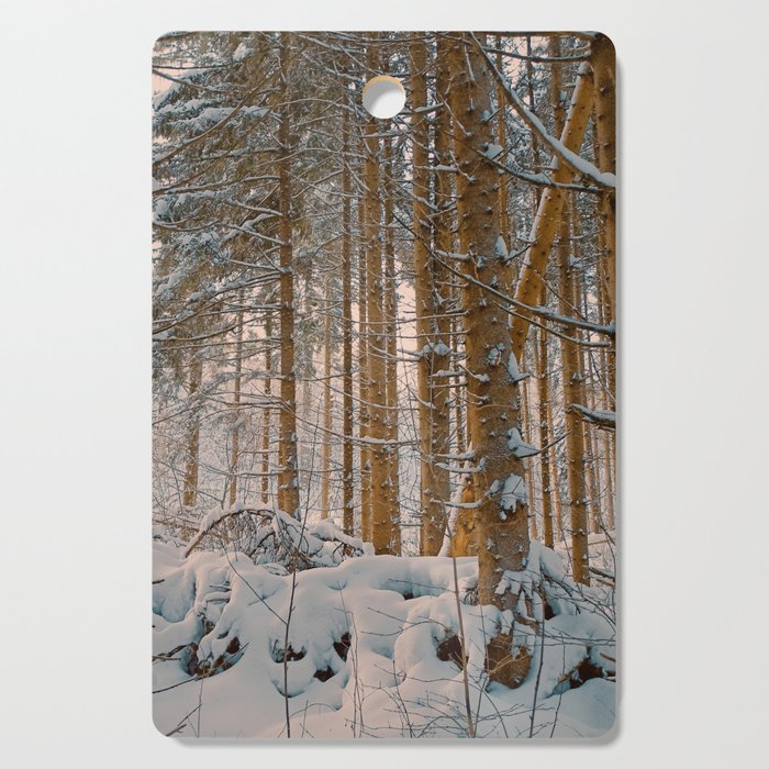 Golden hour in winter forest after snowstorm Cutting Board