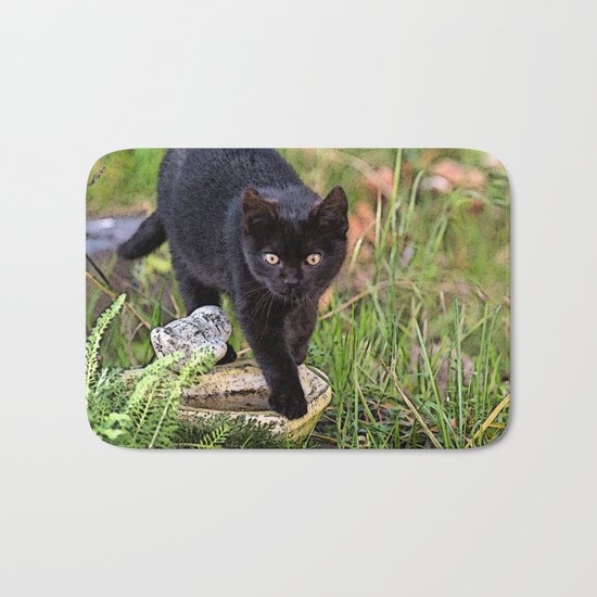 Lovely black cat walking her garden Bath Mat