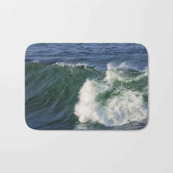 Ducks riding a wave Bath Mat
