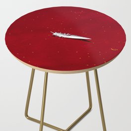 feather floating in red bloody water abstract beautiful surreal shot Side Table