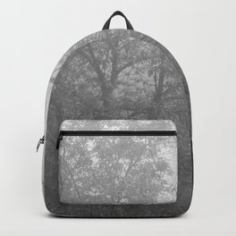 Black and white autumnal naked trees surrounded by fog Backpack