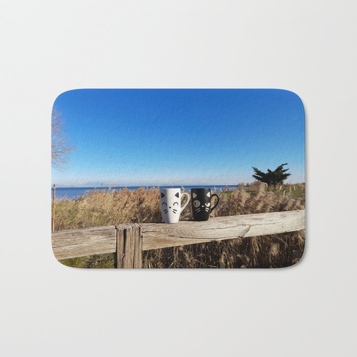 cups with a cat on a background of the sea Bath Mat