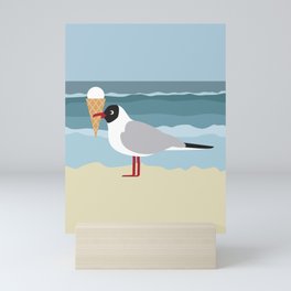 Cute seagull with ice cream by the sea Mini Art Print