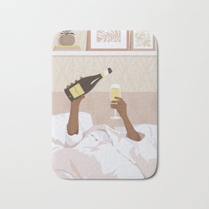 Black woman in bed with bottle of champagne Bath Mat