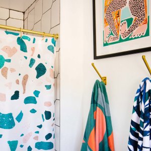 bathroom with terrazzo patterned shower curtain