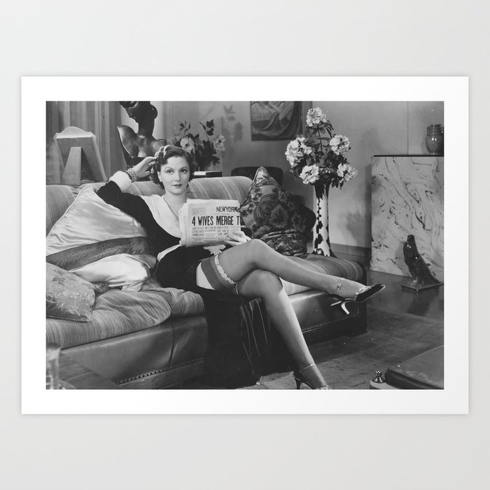 You bring home the bacon and I'll fry it up in a pan ... humorous 1933 housewife in stockings and garter belt reading newspaper on couch black and white photograph Art Print