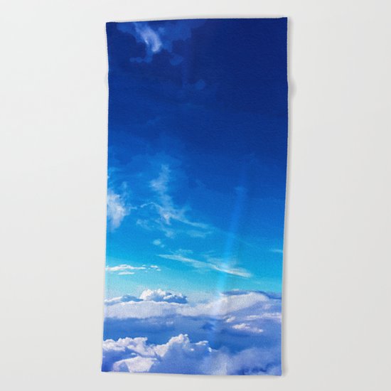 Above the clouds sky is always blue Beach Towel