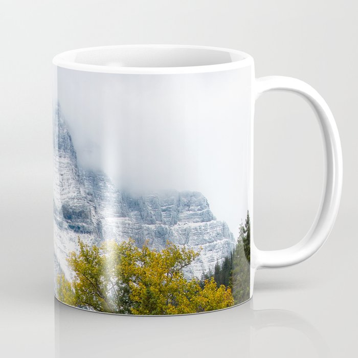 Transitions - Snowy Mountain Peak Overlooking Trees with Fall Color on Autumn Day in Glacier National Park Montana Coffee Mug