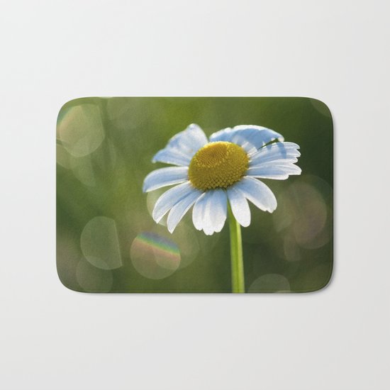 Daisy after rain at backlight Bath Mat