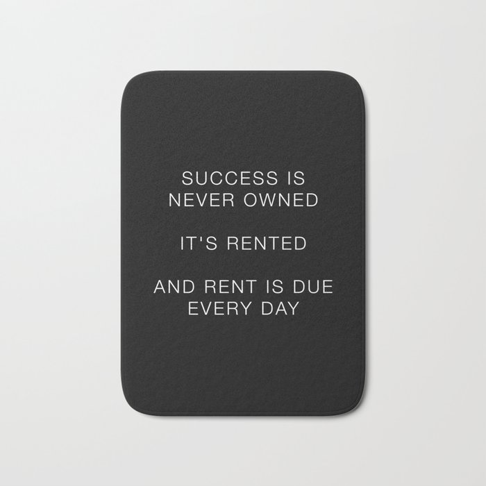 Success is never owned Bath Mat