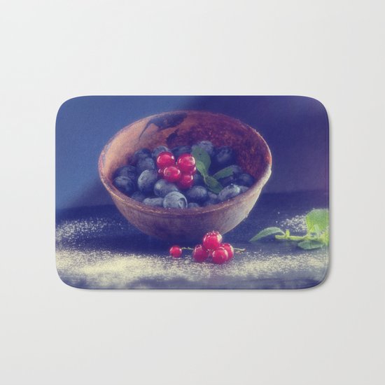 Dark blue berries contrasting with bright red berries Bath Mat