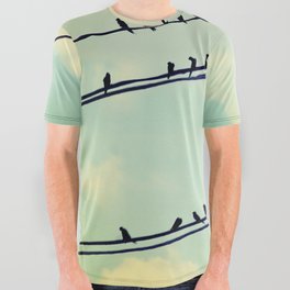 Birds on wires over blue sky with clouds background toned with a vintage retro filter All Over Graphic Tee