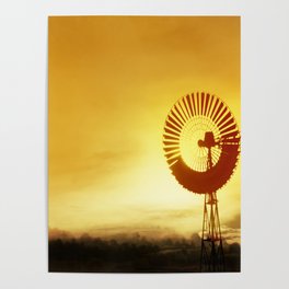 Old windmill used to pump water, cattle on a ranch or farm lit by warm glow of the setting sun.  Poster