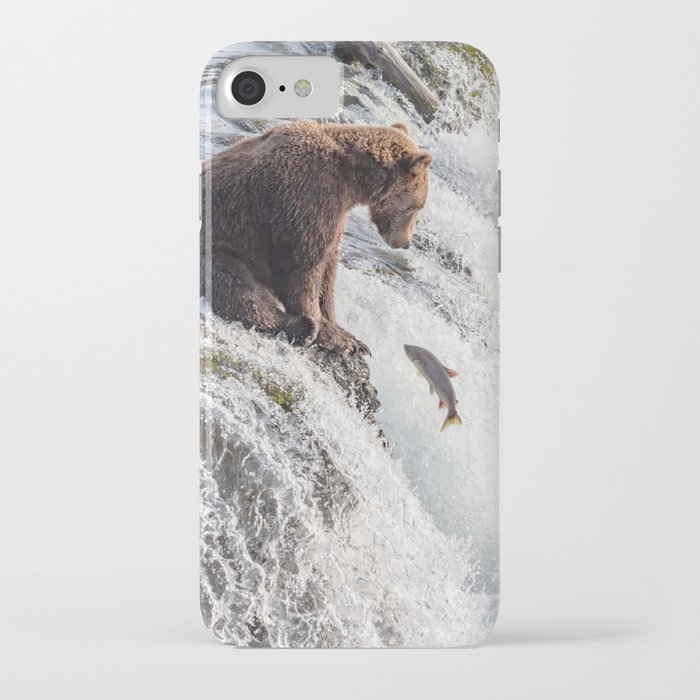 Young grizzly bear sits at waterfall iPhone Case