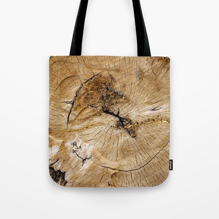 Detail of year rings in worn out tree trunk close-up, weathered and torn Tote Bag