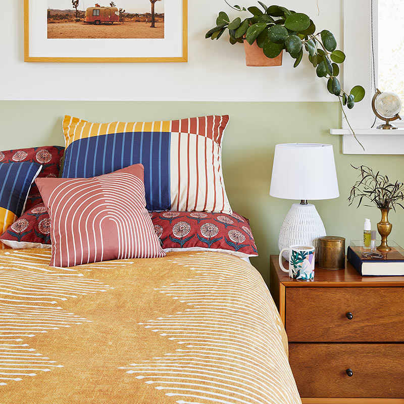 bed with mustard colored duvet cover