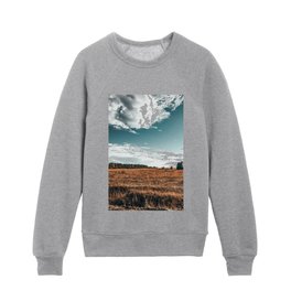 Grass field on sunny day with blue sky in the village and forest   Kids Crewneck