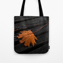 Orange autumn maple leaf on the wooden boards dramatic scene Tote Bag