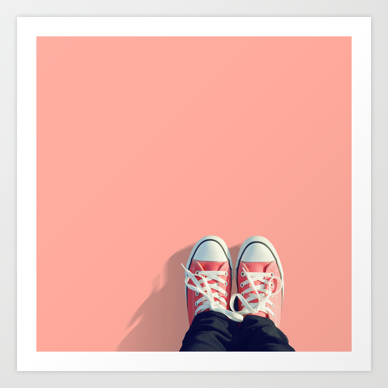 Pink sneakers on a peach-pink colored 