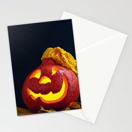 Glowing Pumpkin with Autumn Leaves on a Dark Background. Jack's Lantern. Halloween Decoration Stationery Card