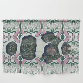Clownfish swimming on a green and pink patterned background Wall Hanging