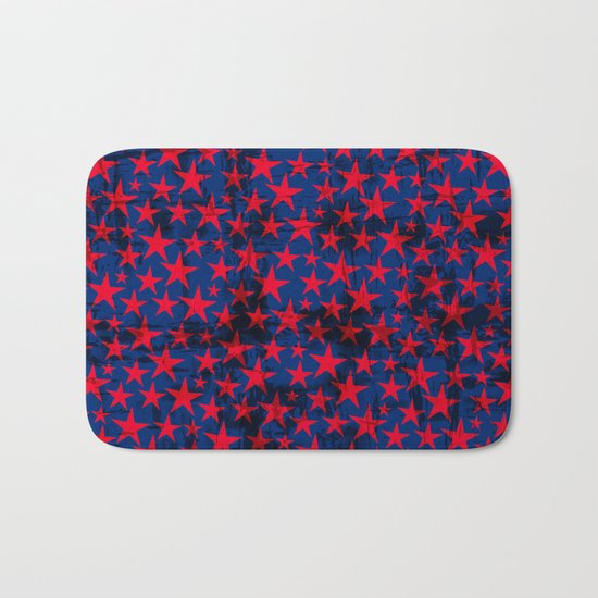 Red stars on grunge textured blue background Bath Mat