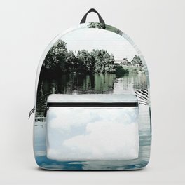 Nature mirror of blue northern lake water on a cloudy day Backpack