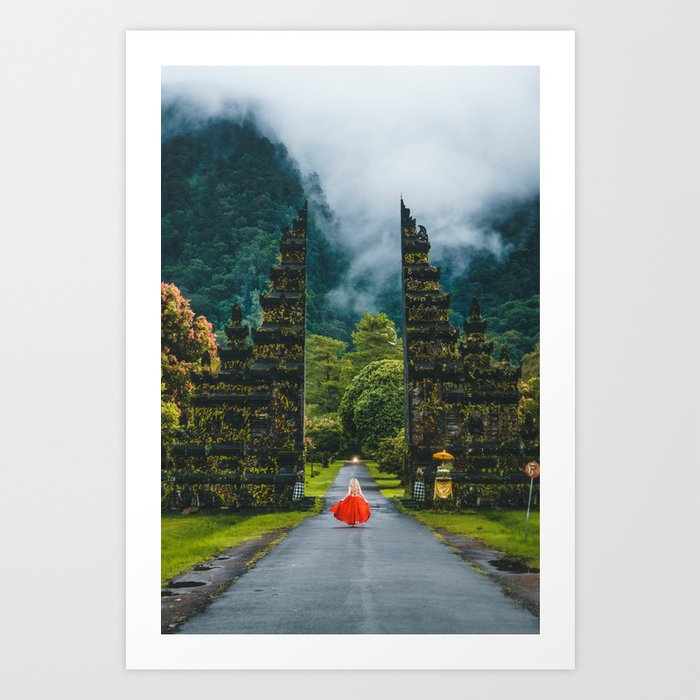 Blonde in red gown running thru the magical Handara Gate, village of Pancasari, Bedegul, tropical island of Bali color landscape photograph / photography Art Print