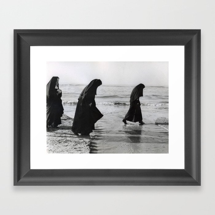 Nuns paddling in the sea at the seaside in the summer months Framed Art Print