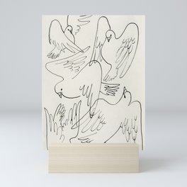 Doves flying in the snow Mini Art Print