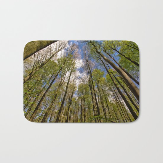 looking up to the trees in the forest Bath Mat