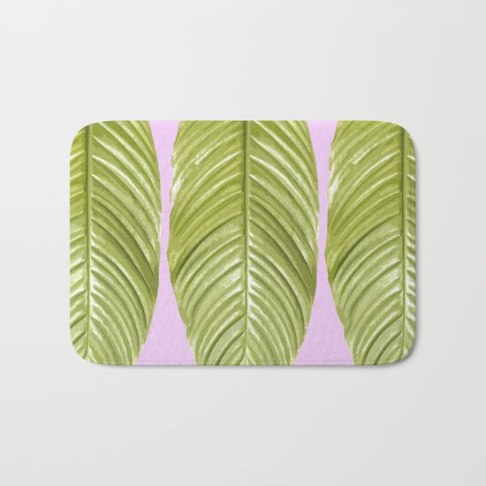 Three large green leaves on a pink background - vivid colors Bath Mat