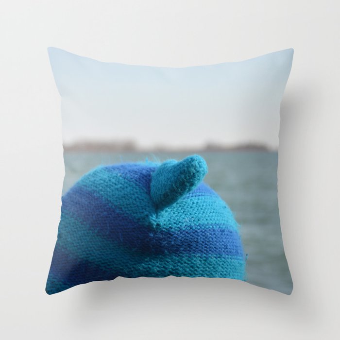 Upper part of a blue winter hat with ears on the head of a young boy in front of a waterfront backgr Throw Pillow