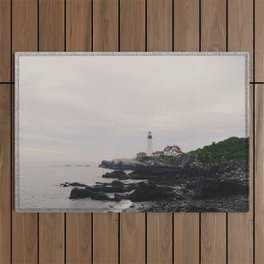 Lighthouse on the coast Outdoor Rug