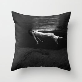 Underwater view of a woman floating in water Throw Pillow