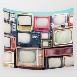 Retro TV receivers set from circa 60s, 70s and 80s of XX century, old wooden television stand with amplifier front mint blue wall background. Broadcasting, news concept. Vintage style filtered photo Wall Tapestry