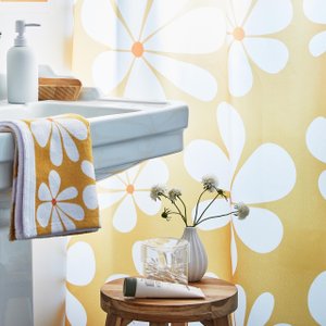 bathroom with yellow and white floral shower curtain & bath towel