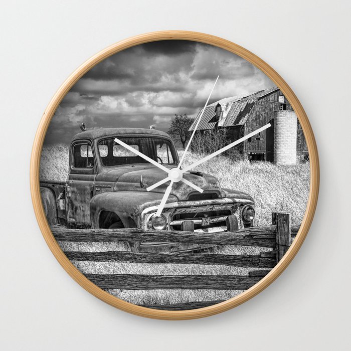 Black and White of Rusted International Harvester Pickup Truck behind wooden fence with Red Barn in Wall Clock