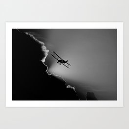Free falling; airplane in the clouds and sky at dusk with rays of sunlight black and white flying photograph art print Art Print