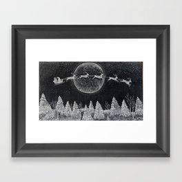 Santa flying over a winter wonderland of snow covered trees in his reindeer drawn sleigh by the light of a full moon Framed Art Print