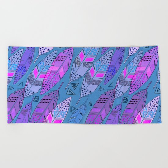 The colorful feathers on blue background . Beach Towel