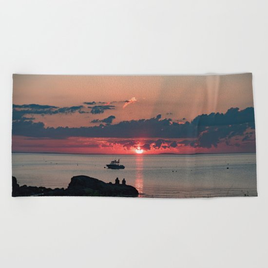 Sunset on the rocks Beach Towel