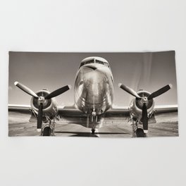 vintage airplane on a runway Beach Towel