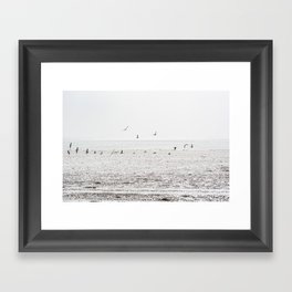 Seagulls fly over a beach in Normandy Framed Art Print