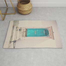 mint green door in a pink building  Rug