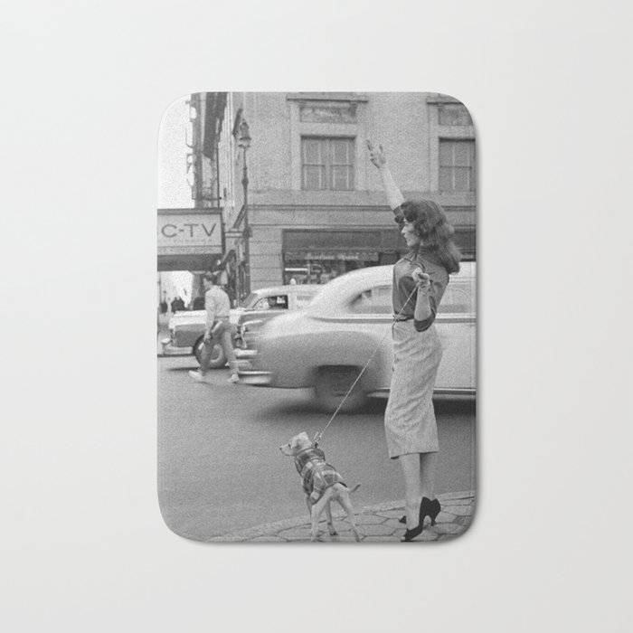 Young woman with pet dog hailing a yellow cab taxi New York City portrait black and white photograph - photography - photographs Bath Mat