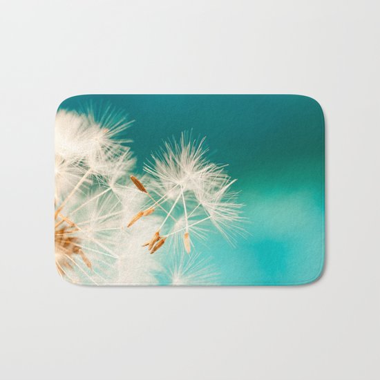 dandelion seeds blowing in turquoise Bath Mat