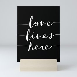 Love Lives Here black and white modern typography minimalism home room wall decor Mini Art Print